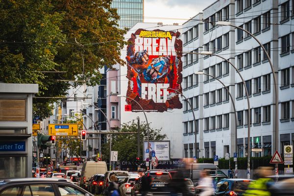 A building end painted with a comic-style figure and bold display lettering