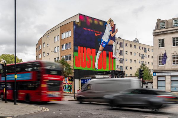 A building end painted with a footballer and large display lettering
